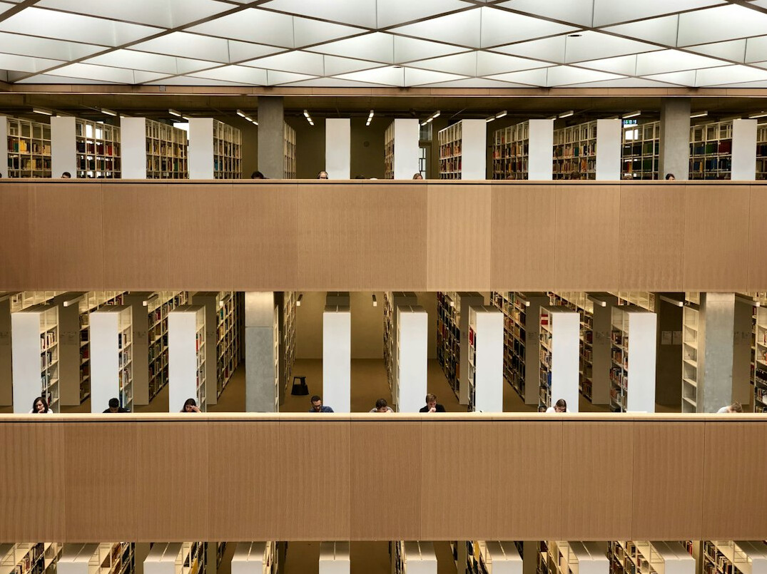 Rows of library shelves with archival volumes