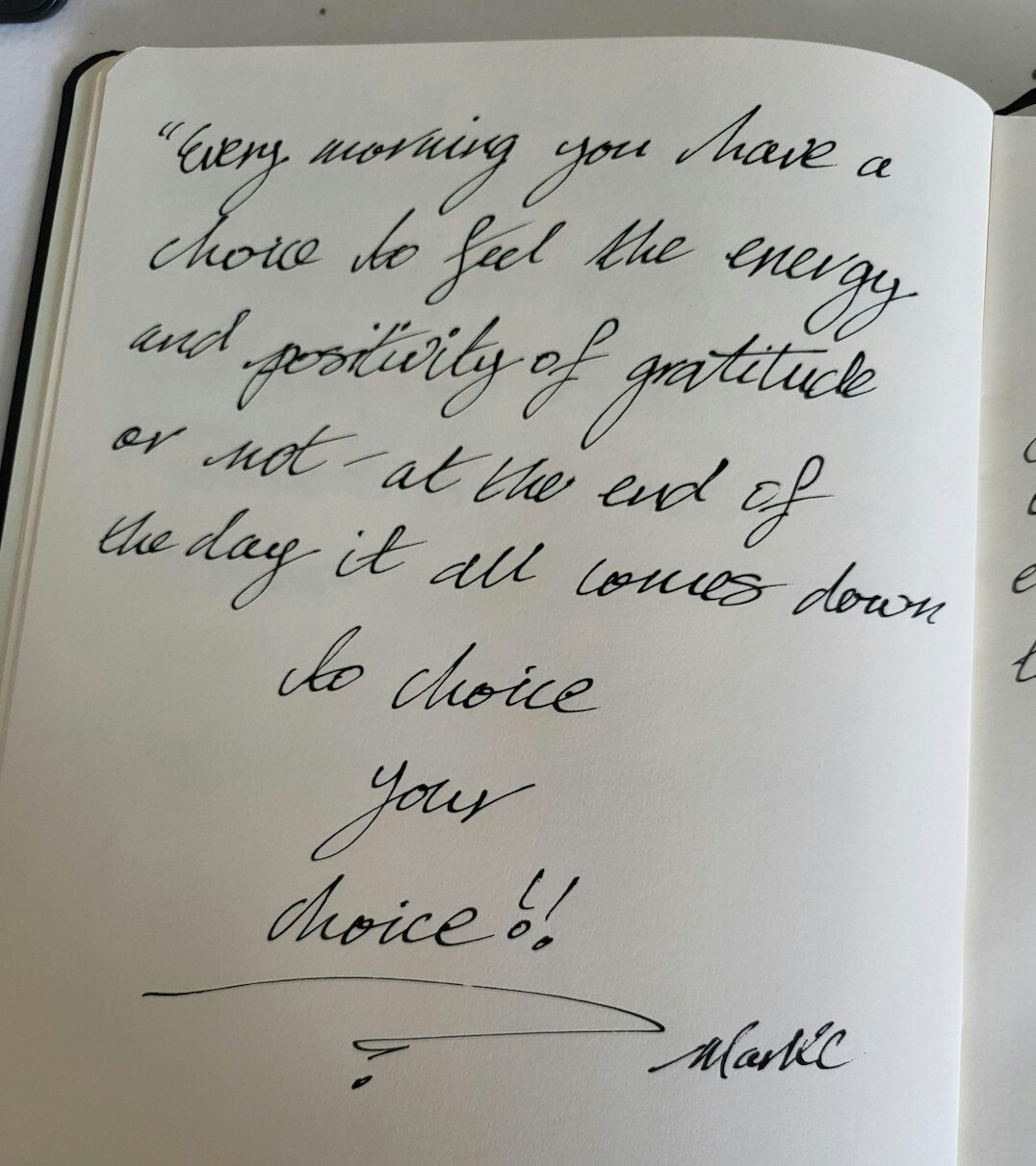 Handwritten notes in a notebook with a pen