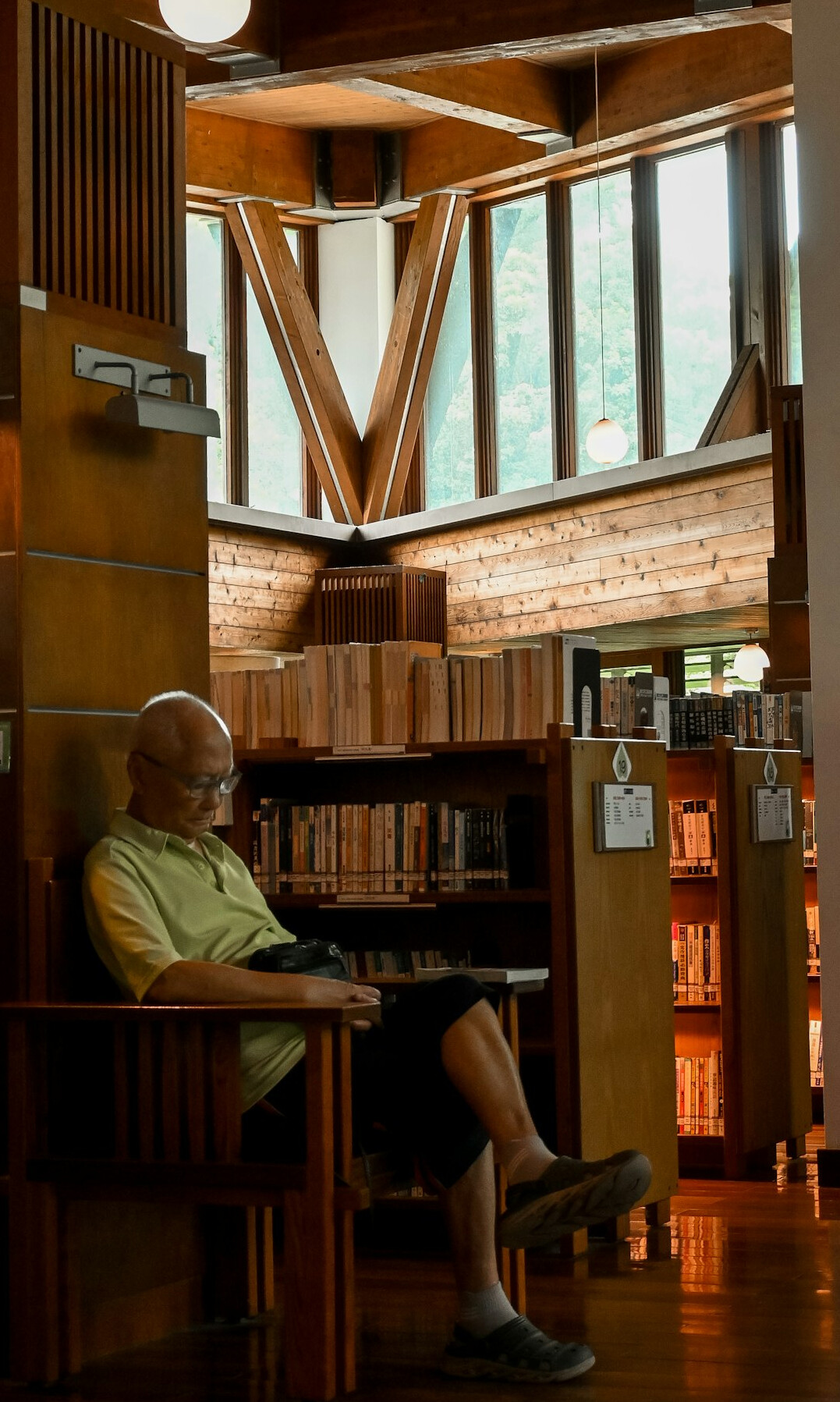 man reading old letters in library